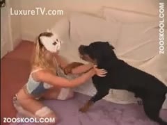 Blonde doxy in mask copulates her dog